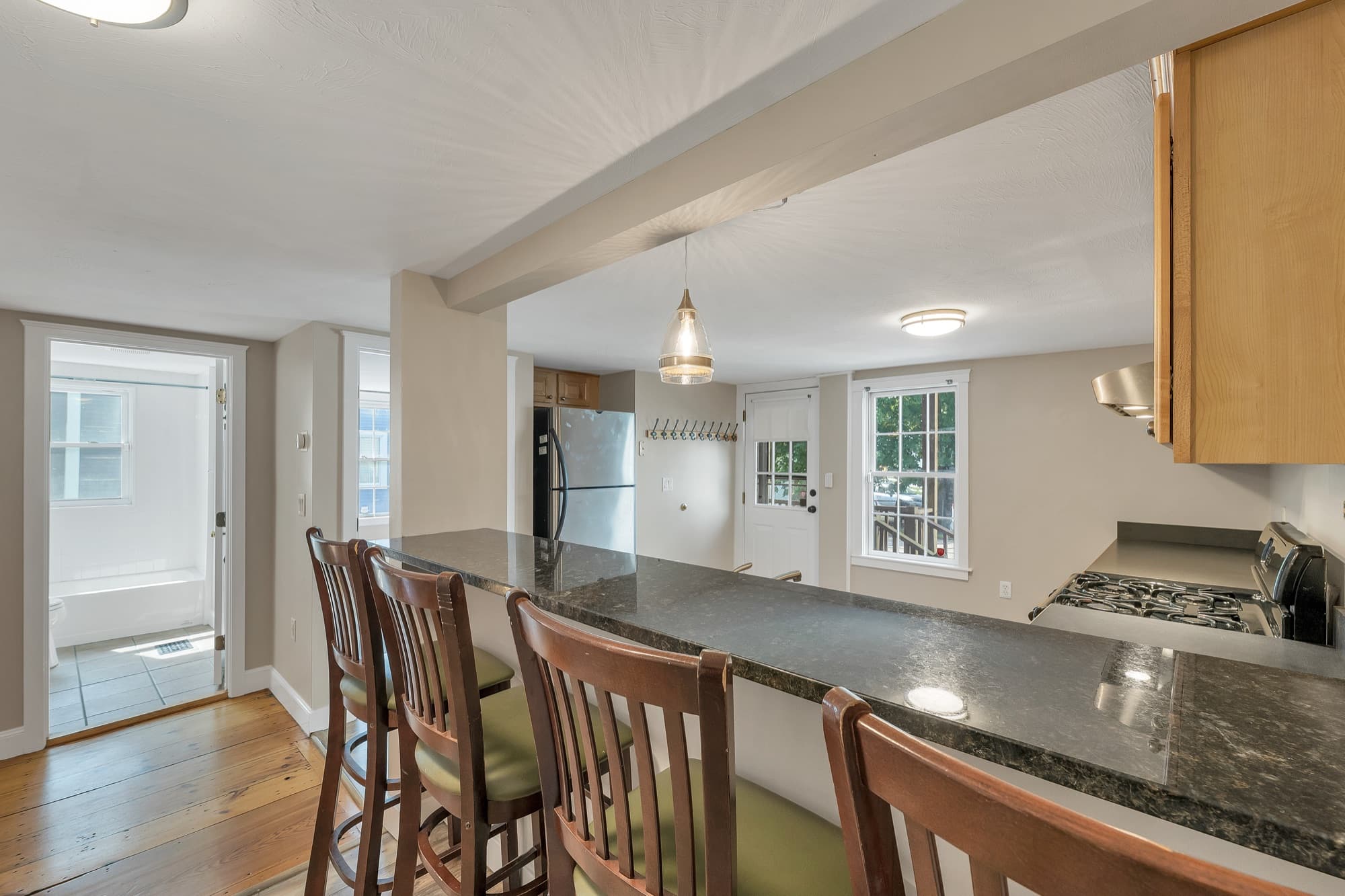 Kitchen peninsula with bar seating, open to the living area