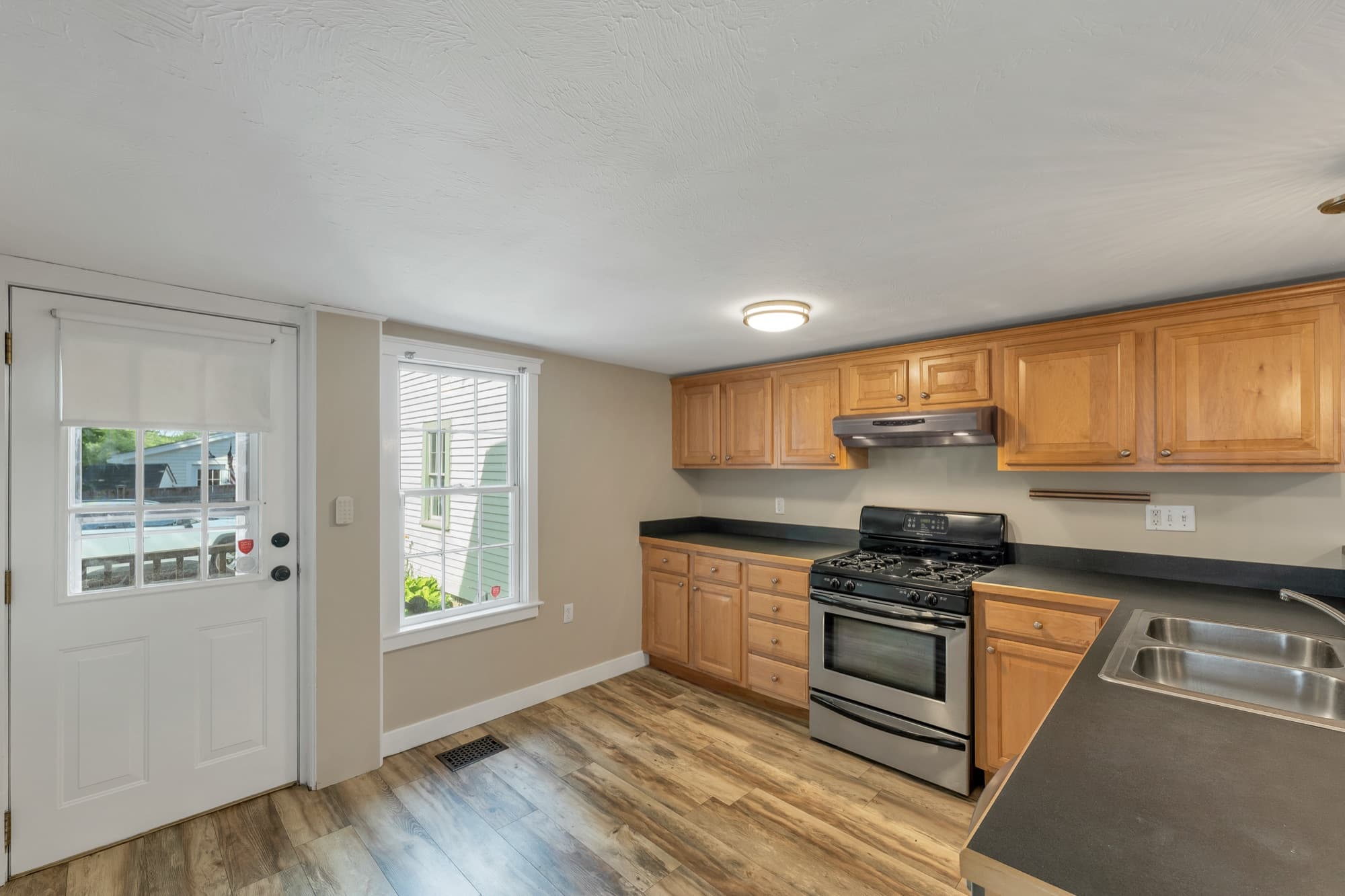 Kitchen with a gas range and an exterior door to the porch