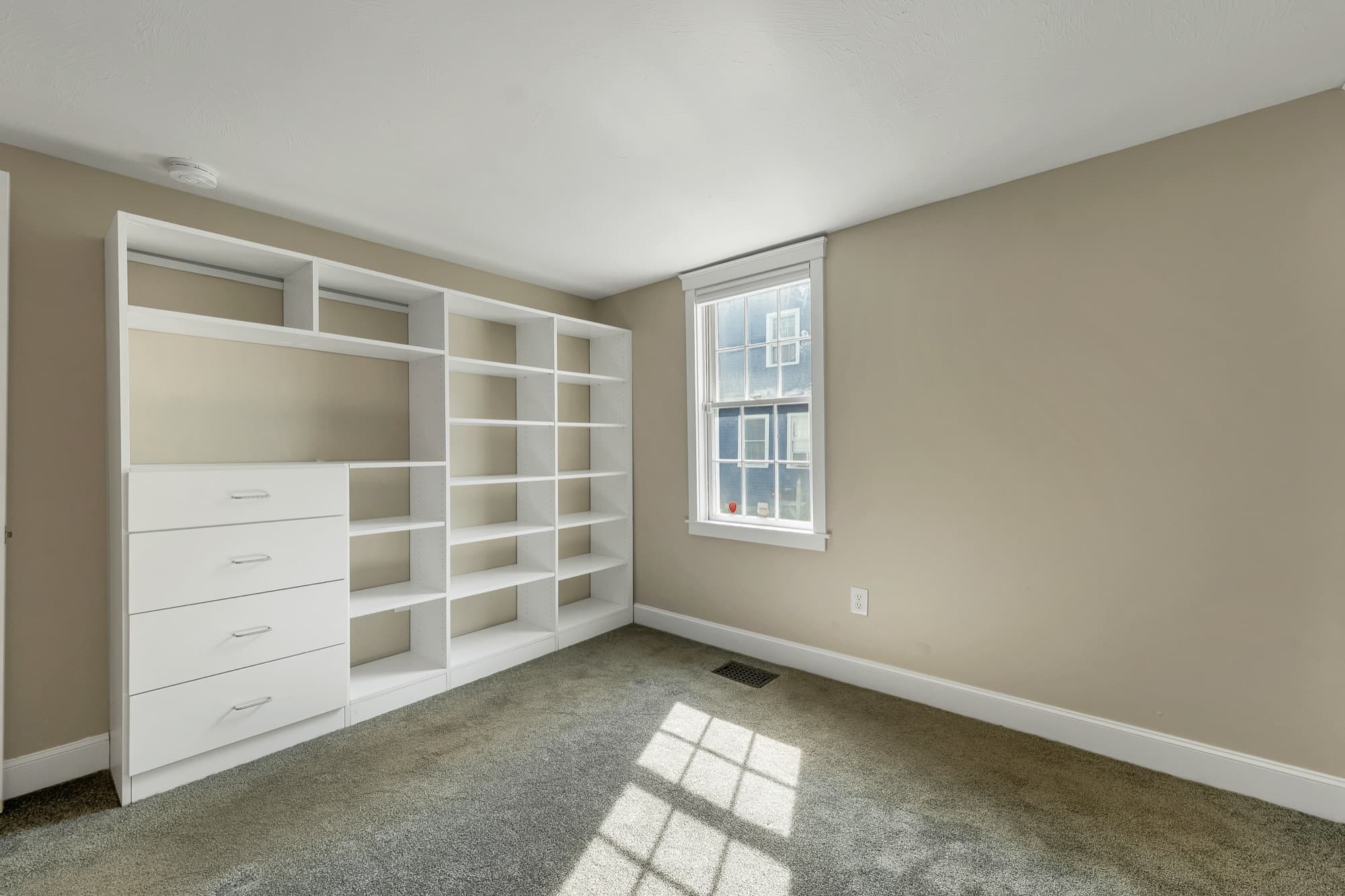 Bedroom with built-in shelving and drawers