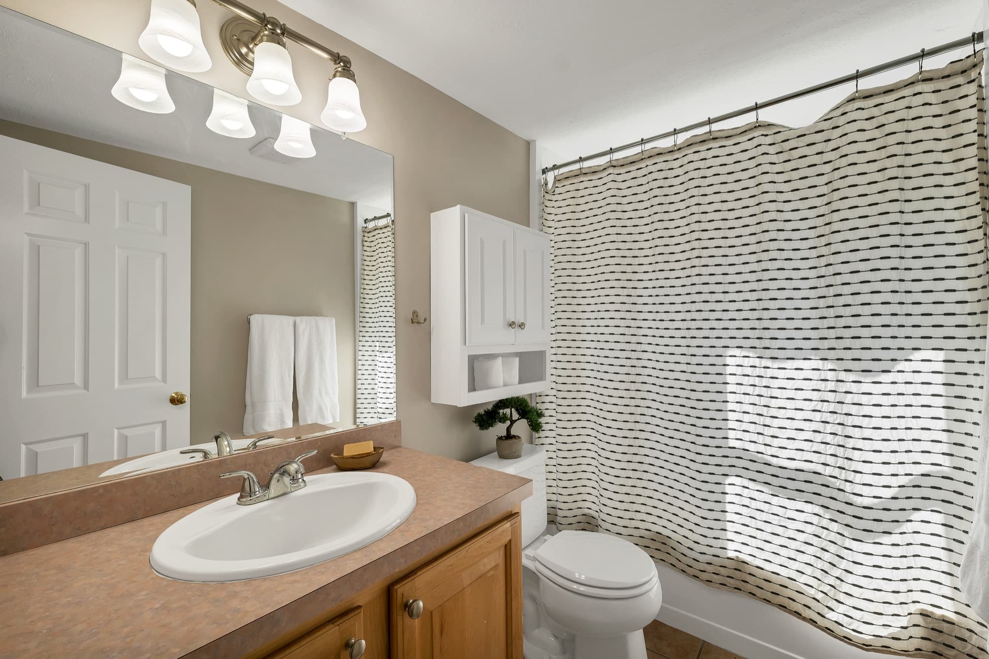 Full bathroom with a vanity and a tub and shower