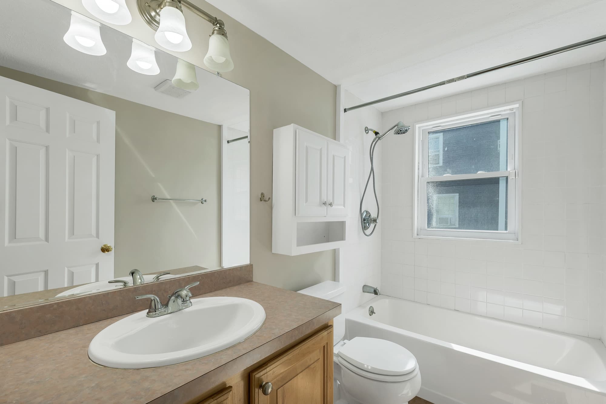Full bathroom with a vanity and a tub and shower