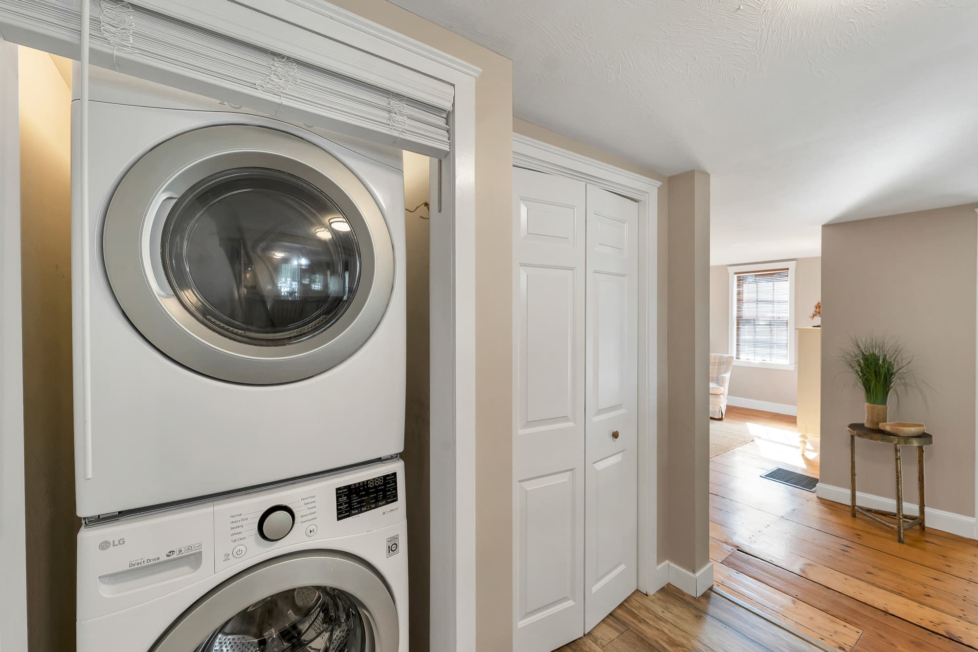 In-unit stacked washer and dryer off the living area